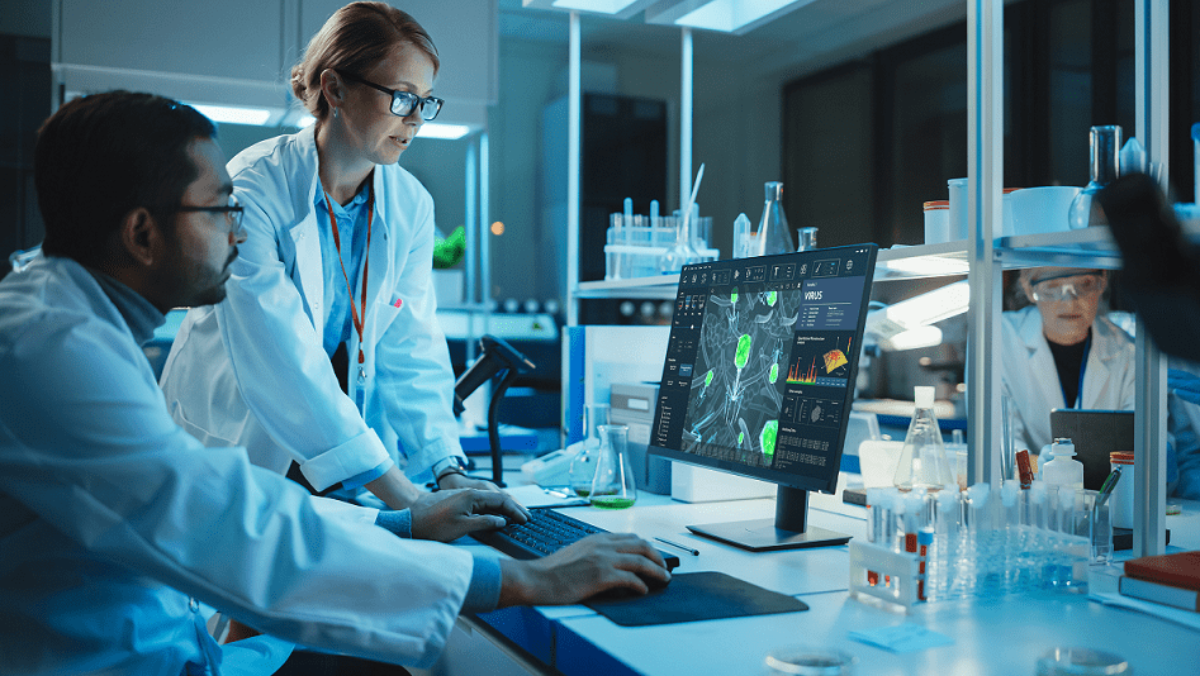 Scientists using AI software to monitor drug fermentation processes in a pharmaceutical laboratory