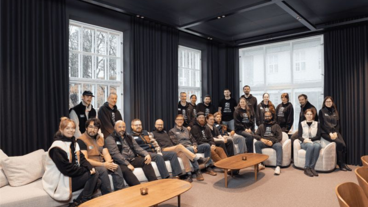 Biotech team gathered indoors for a group photo